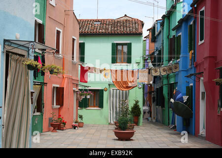 Washing hanging on the line by colourful houses, Burano, Venice. Stock Photo