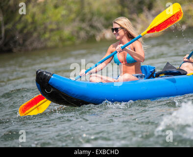 Floating the Boise River, Woman in Bikini having fun kayaking the river. Boise, Idaho, USA Stock Photo