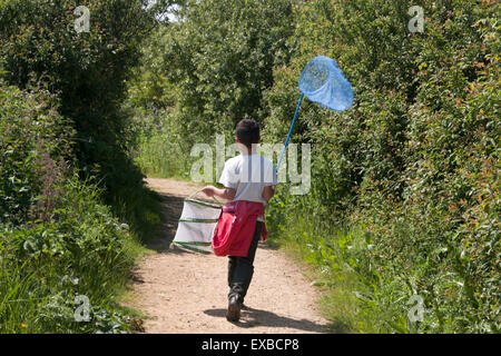 boy with bug catcher and net on bug safari, Pagham Nature Reserve, West Sussex, England Stock Photo