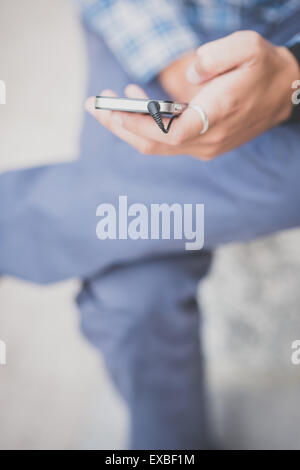 close up hand man using smartphone in the city Stock Photo