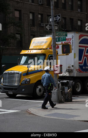 Parked truck on roadside Manhattan New York USA Traffic police officer walking by Stock Photo