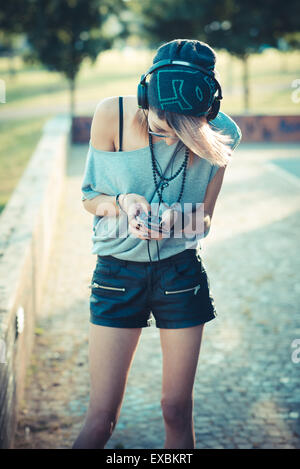 young beautiful model woman listening music in the city Stock Photo
