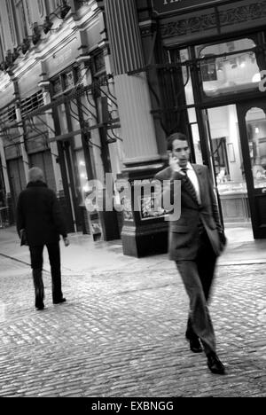 Banker walking through Leadenhall Market, The City of London Stock Photo