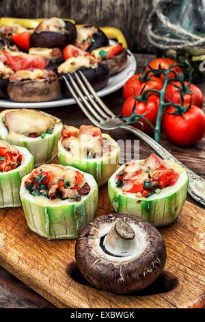 Easy appetizer of zucchini stuffed with cheese,garlic and tomatoes.Photo tinted.Selective focus Stock Photo