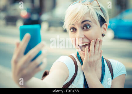 beautiful young blonde short hair hipster woman selfie in the city Stock Photo