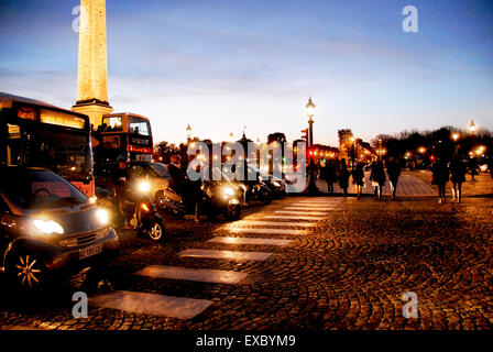 Pedestrians Crossing Place de la Concorde, Paris, France, at Sunset, Traffic Lights on Red Stock Photo