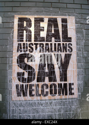 Perth, Australia. 11th July, 2015. As a nation built on immigration and multiculturalism, not all Australians support their government's hardline stance against asylum seekers: grass-roots campaigns are cropping up all over the country advocating for a more humanitarian approach to refugees. REAL AUSTRALIANS SAY WELCOME posters recently originated in Melbourne, Victoria, but are now starting to appear on city walls 3500km away in Perth, Western Australia (pictured). Credit:  Suzanne Long/Alamy Live News Stock Photo