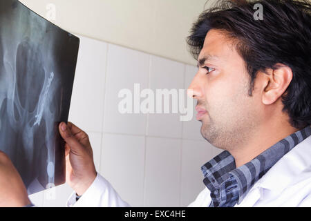 1 indian man doctor hospital X-Ray report Checking Stock Photo