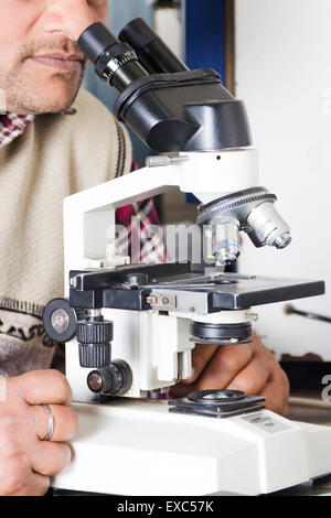 1 indian man hospital Microscope Machine Checking Stock Photo