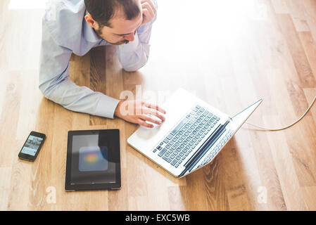 elegant business multitasking multimedia man using devices at home Stock Photo