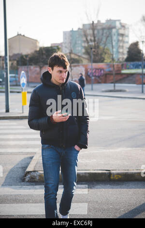 young handsome man using smartphone in the city Stock Photo