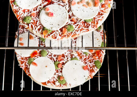 Two frozen pizzas ready to be baked Stock Photo