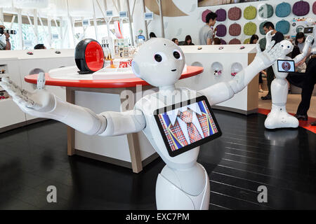 Tokyo, Japan. 11th July, 2015. The humanoid robot Pepper debuted as a new member of staff at the NESCAFE coffee-shop in Harajuku on July 11, 2015, Tokyo, Japan. Six robots are programmed to interact with people while introducing the Nescafe products during a special event ''The world? Future cafe by NESCAFE with Pepper'' on Saturday July 11th. The store will continue to employ two robots as regular staff to introduce the shop's products and services. Credit:  Rodrigo Reyes Marin/AFLO/Alamy Live News Stock Photo