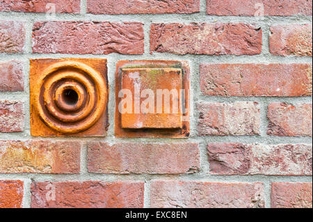 Decorative stones in a brick wall Stock Photo