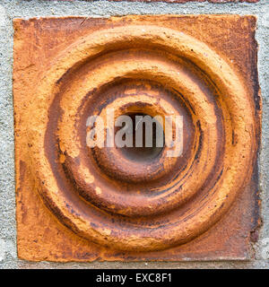 Decorative stone in a brick wall Stock Photo