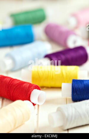 Spools of thread on a white background lined up in color Stock Photo ...