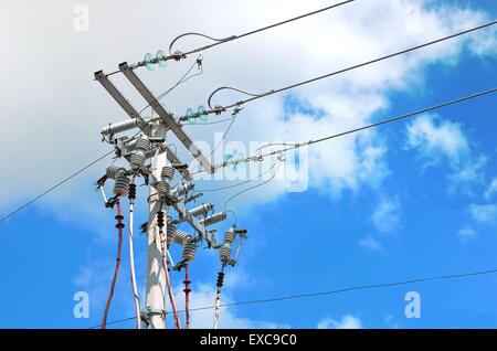 Electric pole in front of a clouded blue sky Stock Photo - Alamy