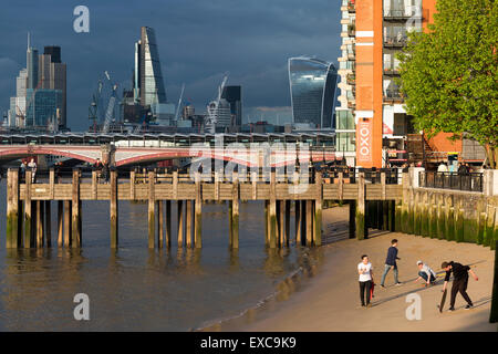 People playing on a River Thames beach near the Oxo Tower & Gabriel's Wharf, Southbank London, England, UK. Stock Photo