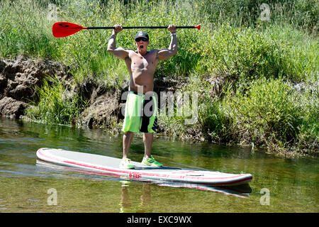 Stand up paddle boarding man, Roaring Fork River, near Aspen, Colorado USA Stock Photo