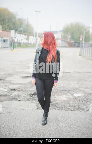young beautiful red hair venezuelan woman lifestyle in the city of milan outdoor street Stock Photo