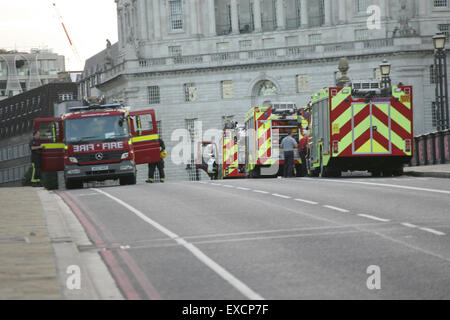 London, UK. 11th July, 2015. Firefighters at the scene - emergency services attended an incident at Lambeth Bridge after a man was seen hanging from the underside of the bridge. Credit:  Finn Nocher/Alamy Live News Stock Photo