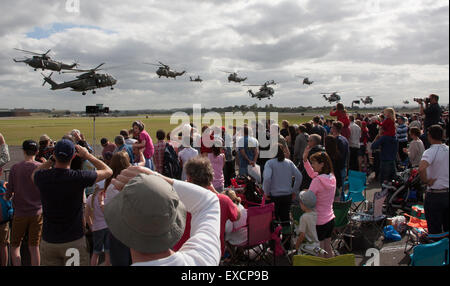 Yeovilton, Somerset, UK. 11th July, 2015. On completion of the Helicopter Assault Finale which closed the show the helicopters of the Merlin and Sea King Helicopters Commando Helicopter Force gathered in front of the croed with the supporting Apache Helicopters of the Army Air Corps along with the Lynx and Wildcat maritime helicoptes from . 37,000 people made their way to the Royal Naval Air Station Credit:  David Billinge/Alamy Live News Stock Photo