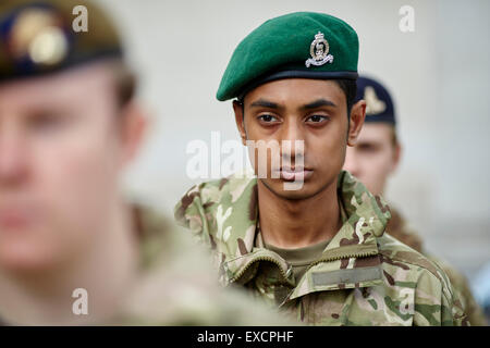 ARMED FORCES DAY IN MANCHESTER CITY CENTRE.  Green berry cap cadet asian black Man men male his him he gentleman partner lads bo Stock Photo