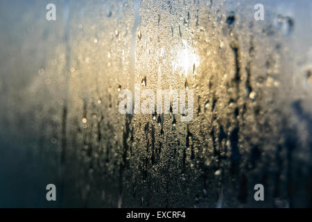 Mist and raindrops on glass pane after a night of rain Stock Photo