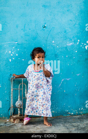 A young 2-5 year old Wayuu indigenous girl outside her home in a low-income neighborhood of Uribia, La Guajira, Colombia. Stock Photo