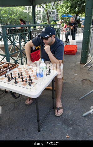 Man contemplates his next chess move at game in Union Square in New York City. Stock Photo