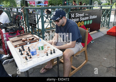 Man contemplates his next chess move at game in Union Square in New York City. Stock Photo