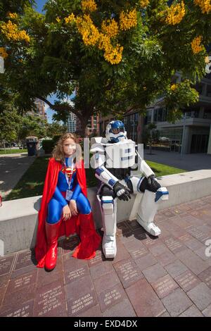 San Diego, CA, US. 11th July, 2015. COMIC-CON INTERNATIONAL returns to San Diego. People come from all over the world to attend the four day event. Some come without passes, just to people watch. There are all kinds of activities for all who brave the crowds. Seen here: Supergirl, and Halo taking a break.Supergirl Rory Dawson 11 years old from San Diego, and Halo Shane Holly 38 also from San Diego Credit:  Daren Fentiman/ZUMA Wire/Alamy Live News Stock Photo