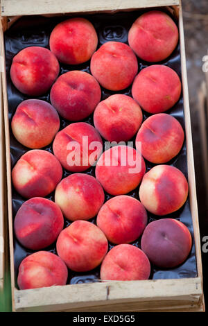 Fresh nectarines selling in a market. Vertical shot with a selective focus Stock Photo