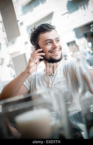 young stylish man at the bar on the phone Stock Photo