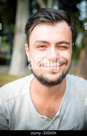 close up portrait of youg stylish man winking Stock Photo