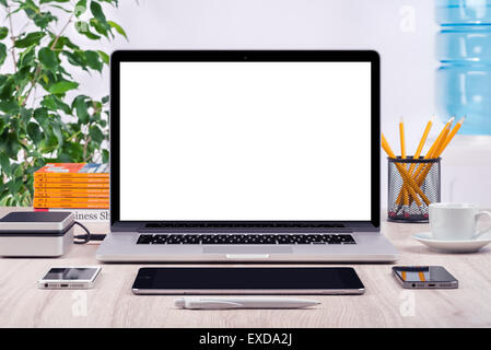 Workplace with open laptop mockup different gadgets and office supplies on the desk. For design presentation or portfolio. Stock Photo
