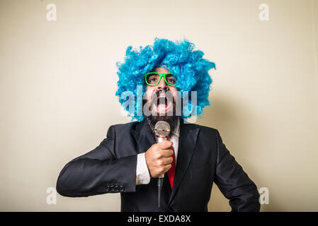 crazy funny bearded man with blue wig on white background Stock Photo