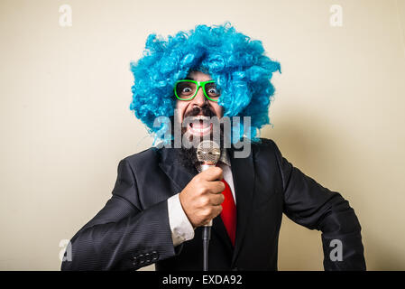 crazy funny bearded man with blue wig on white background Stock Photo