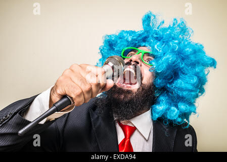 crazy funny bearded man with blue wig on white background Stock Photo