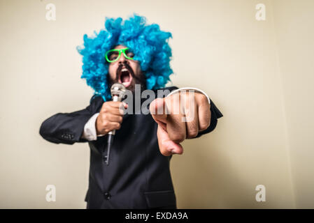 crazy funny bearded man with blue wig on white background Stock Photo