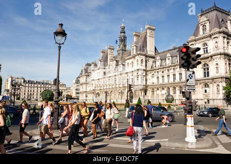 Pedestrians crossing in front of Hotel de Ville in summer Paris, France. Stock Photo