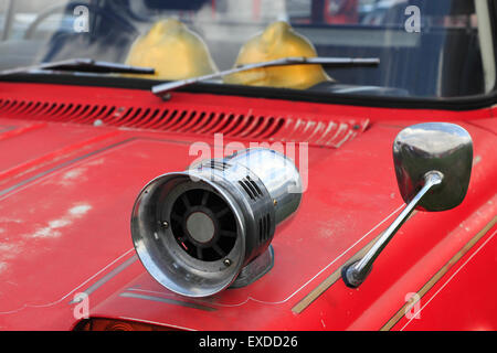Closeup of old fire truck with a siren on the fender.