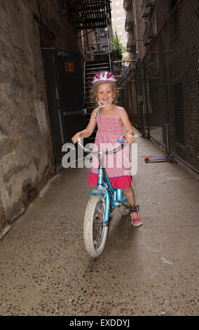 Young girl sitting on her bicycle New York USA Stock Photo