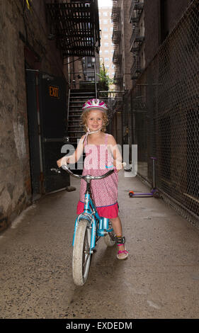 Young girl sitting on her bicycle New York USA Stock Photo