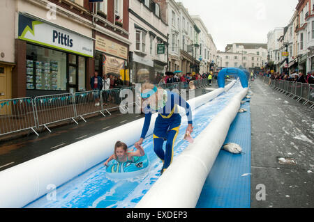 Isle of Wight, UK. 12th July, 2015. Bestival waterslide down Ryde high street on the Isle of Wight. The event will see around 300 people slide down a 200m inflatable waterslide on lilos. 12 July 2015. Credit:  Rob Wilkinson/Alamy Live News Stock Photo