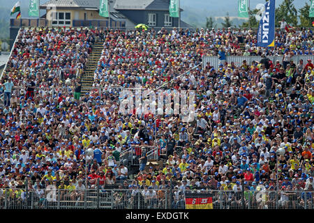 Hohenstein-Ernstthal, Germany. 12th July, 2015. Spectators observe the race on the stands during the Motorcycle World Championship Grand Prix of Germany at the Sachsenring racing circuit in Hohenstein-Ernstthal, Germany, 12 July. Credit:  dpa picture alliance/Alamy Live News Stock Photo