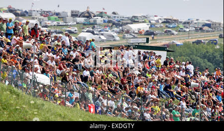 Hohenstein-Ernstthal, Germany. 12th July, 2015. Spectators observe the race during the Motorcycle World Championship Grand Prix of Germany at the Sachsenring racing circuit in Hohenstein-Ernstthal, Germany, 12 July. Credit:  dpa picture alliance/Alamy Live News Stock Photo