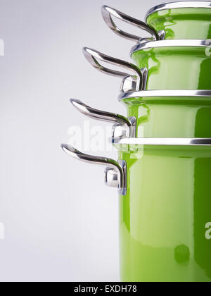 Set of four stacked green enamel pots Stock Photo