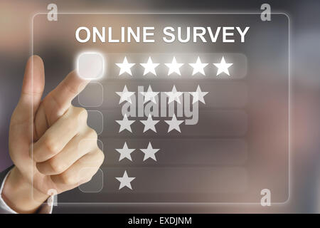 business hand clicking online survey on virtual screen interface Stock Photo