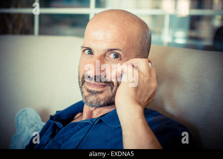 miggle age man using phone at home Stock Photo